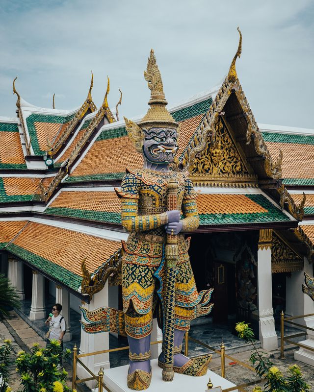 Layered temple roofs with green and gold tiles and ornate eaves.