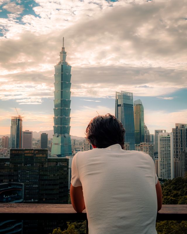 Taipei 101 rising above the city, seen from an elevated viewpoint.