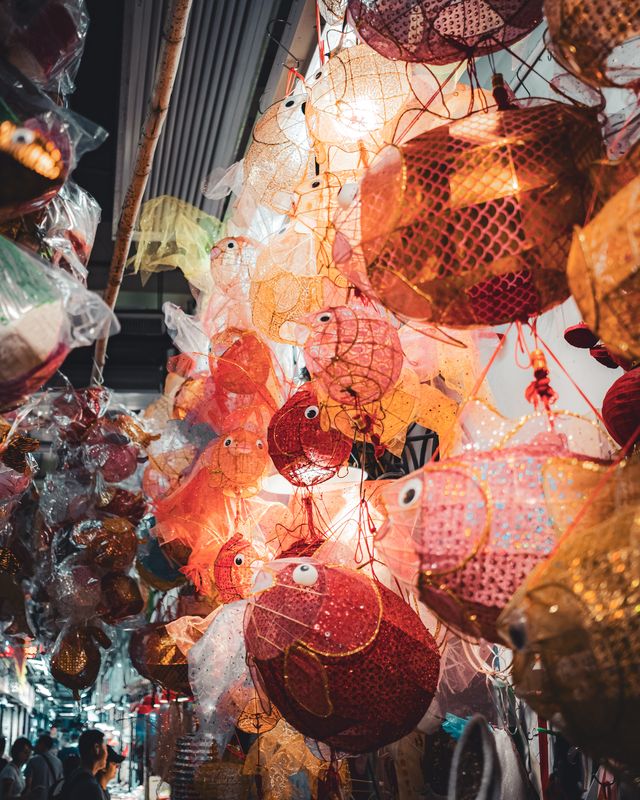 Red lanterns glowing at a Mid-Autumn Festival market.