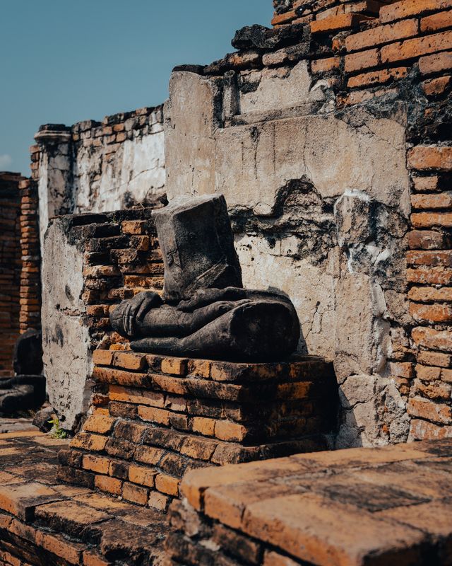 Ancient stone structures casting deep shadows.
