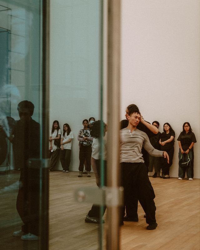 A dancer turning in front of a mirror.