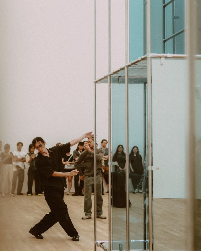 A dancer moving through a bright studio.