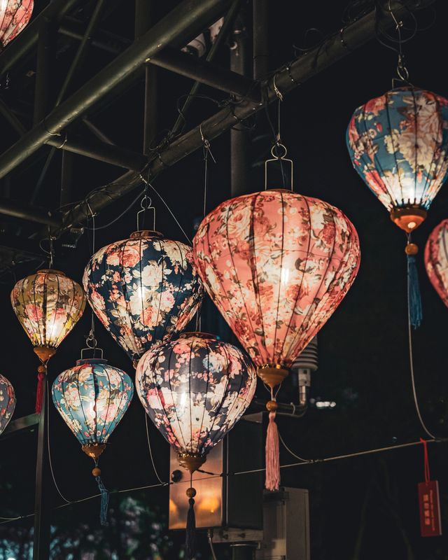 Large pink lanterns forming a glowing tunnel.