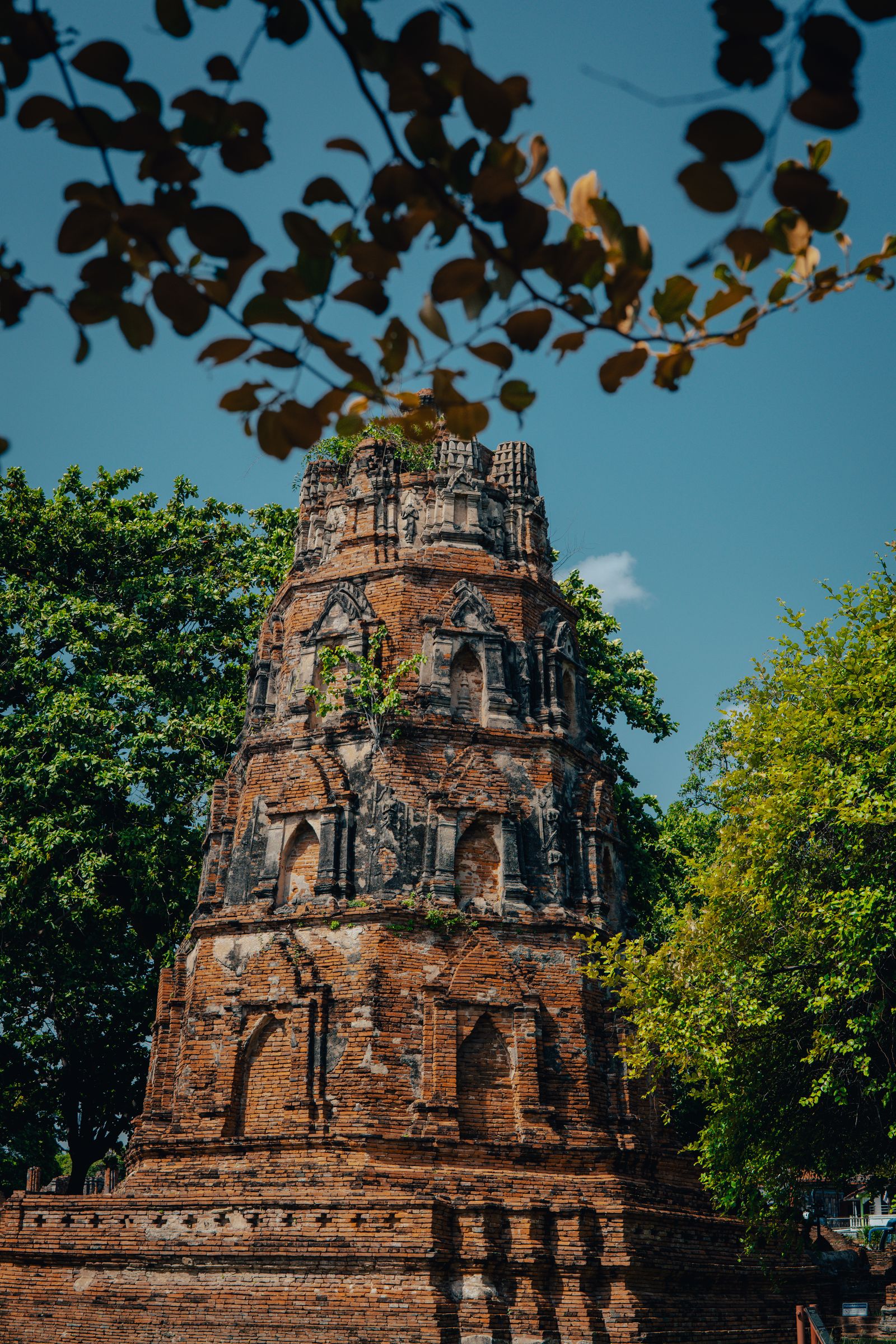A tall brick ruin rising against the sky in Ayutthaya.
