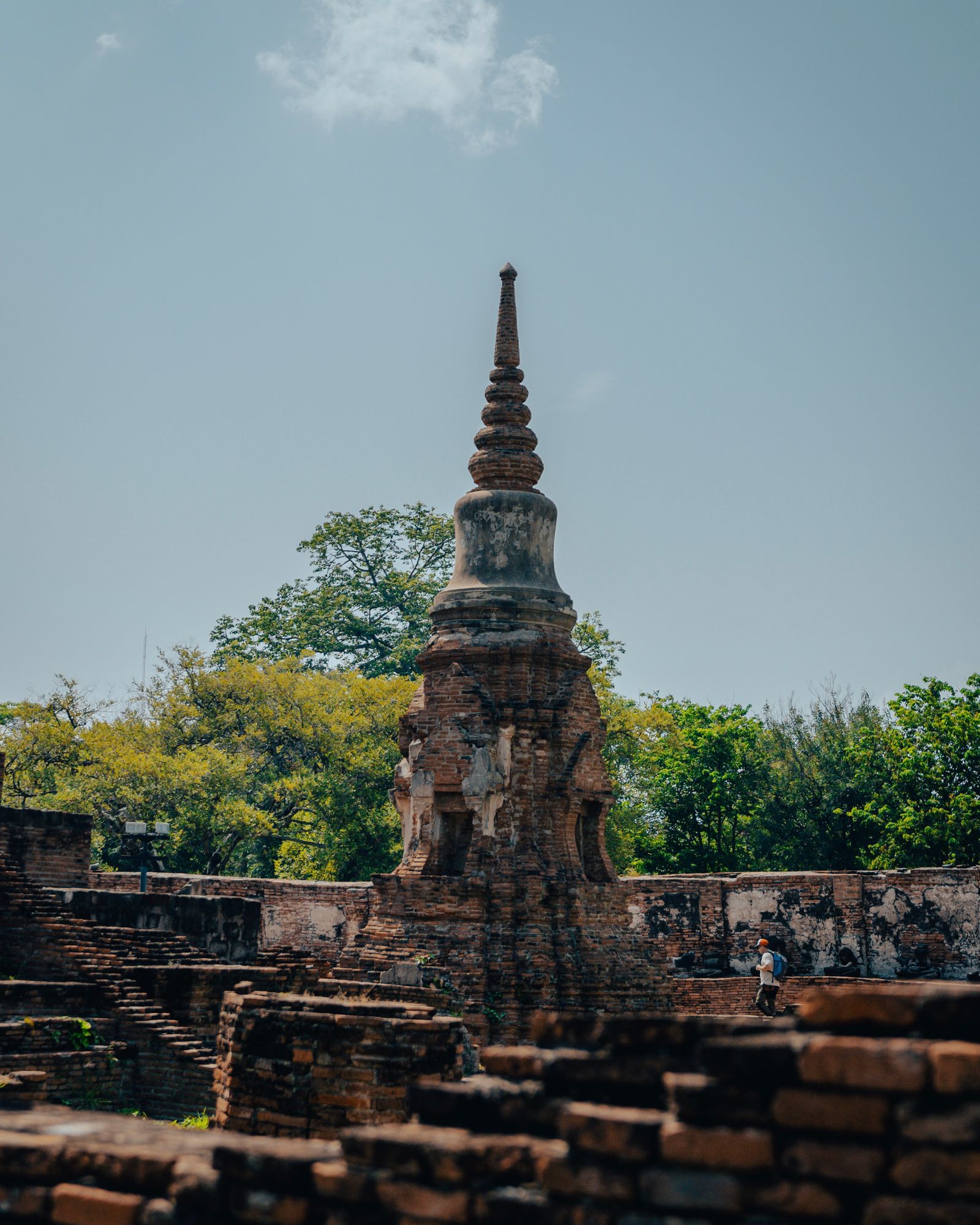A tall stupa rising above the ruins of Ayutthaya.