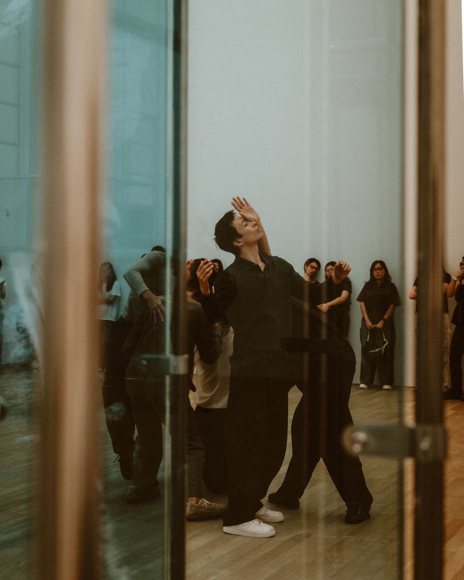 Dancers holding a pose during rehearsal.