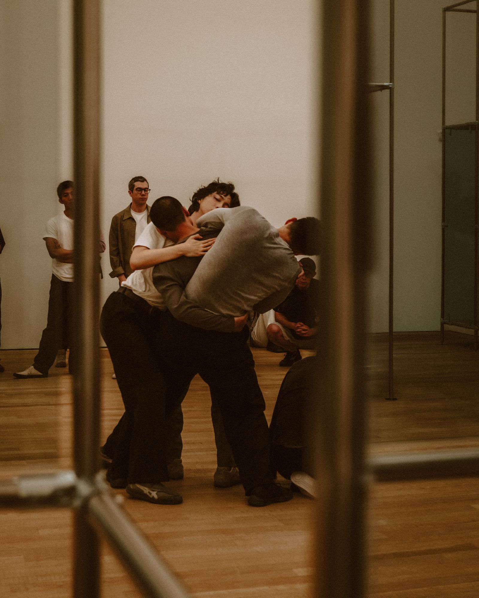 Dancers rehearsing in a mirrored studio.