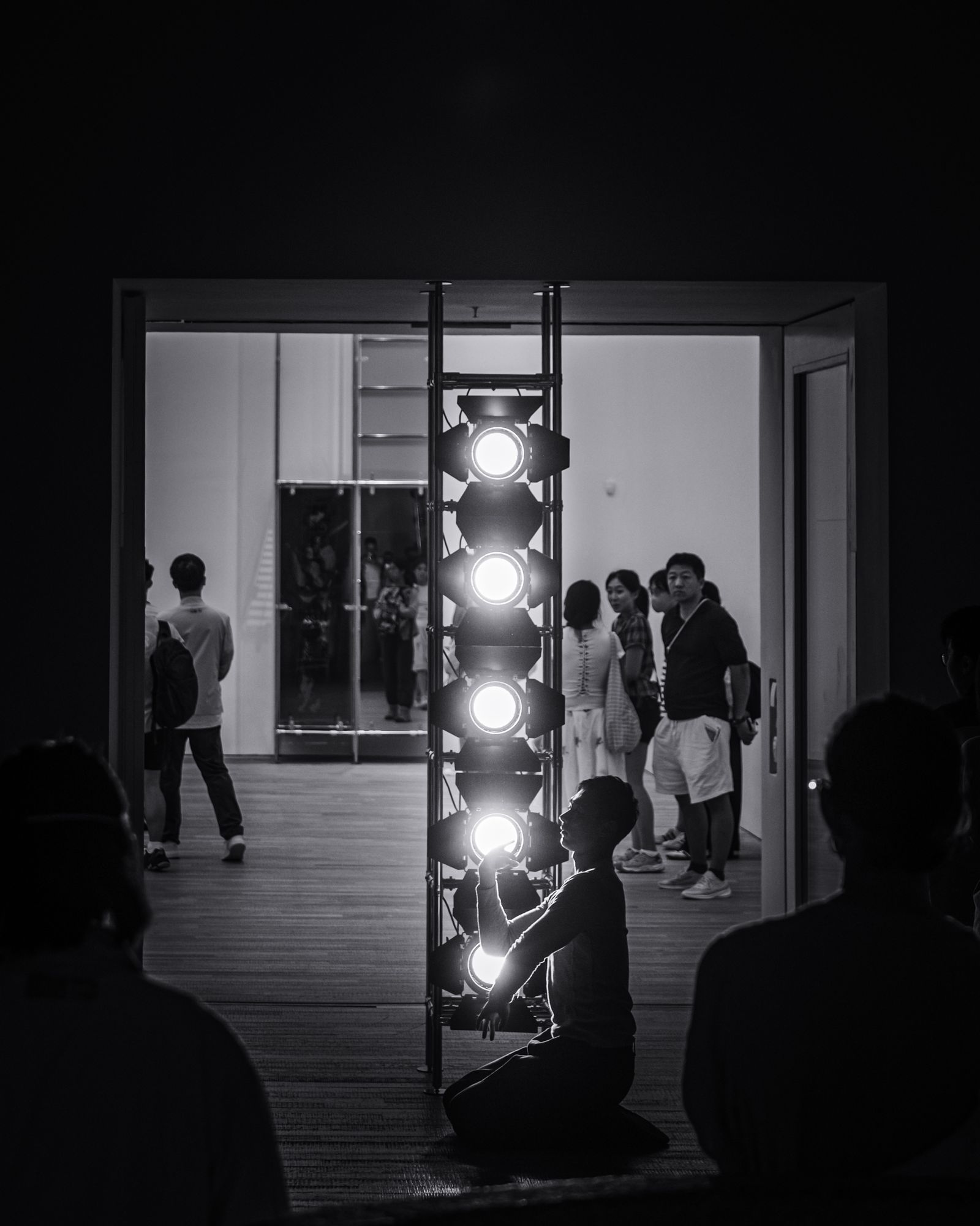A dancer stretching in a studio doorway.