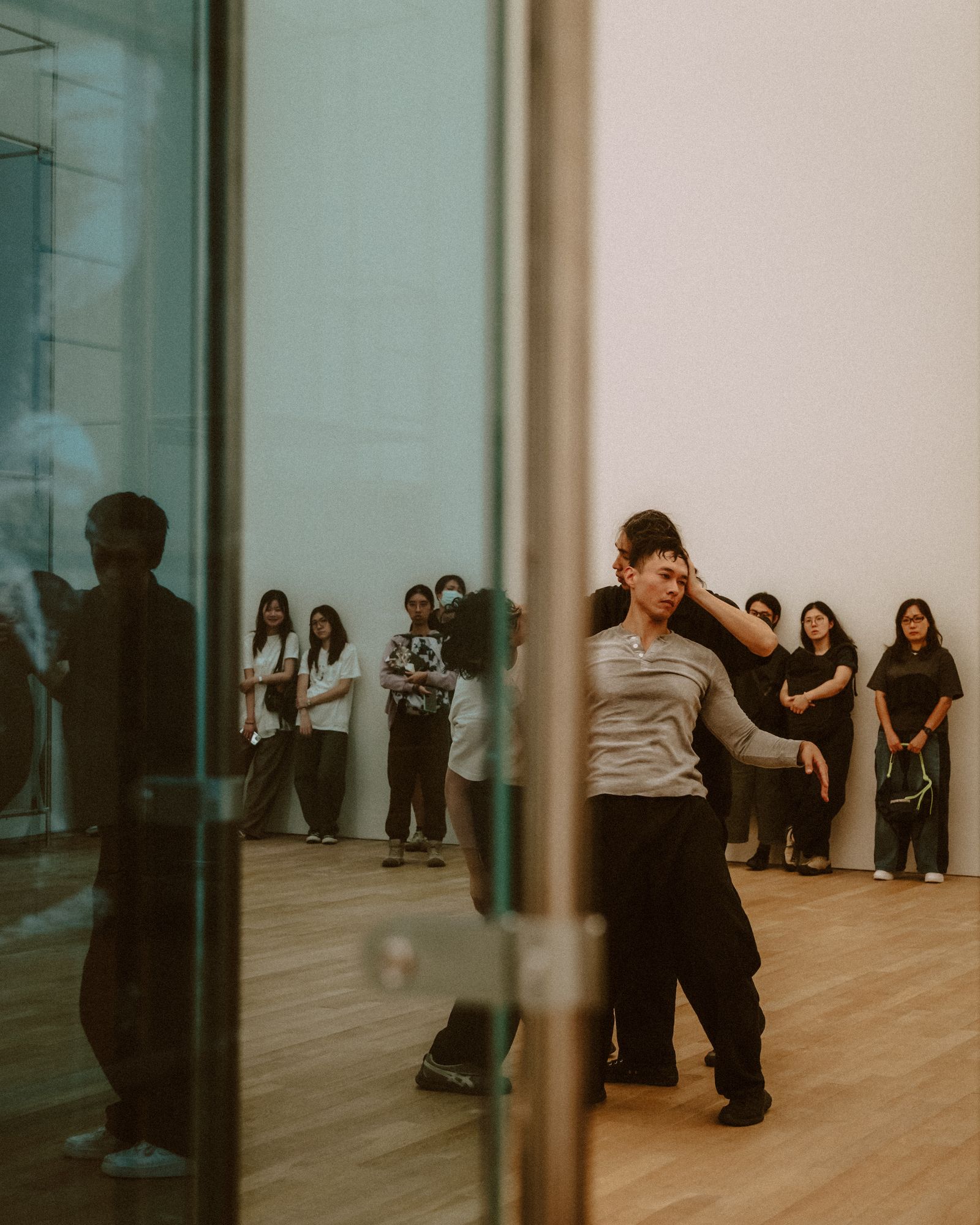 A dancer turning in front of a mirror.