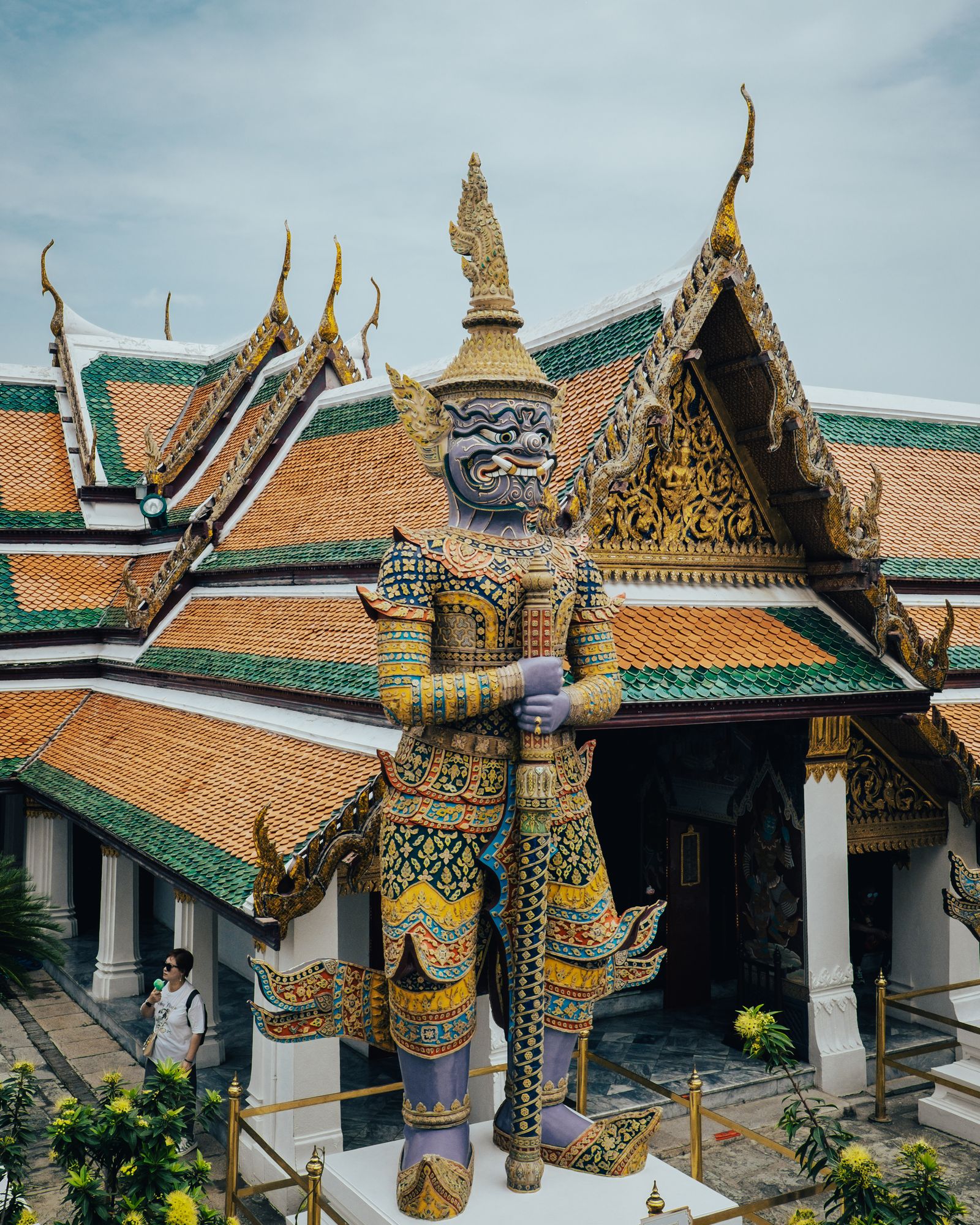 Layered temple roofs with green and gold tiles and ornate eaves.