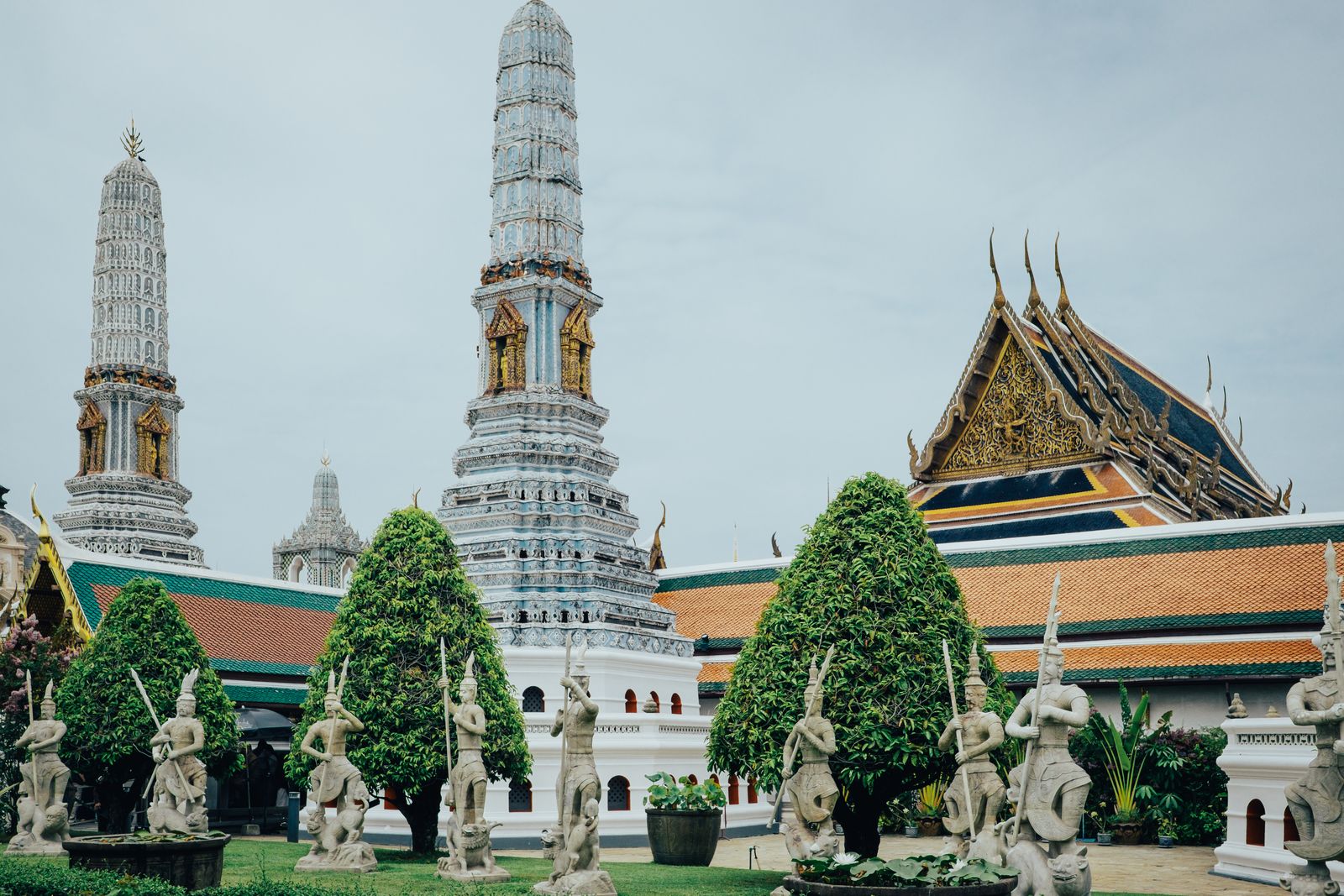 The white spires of Wat Arun rising above a temple courtyard in Bangkok.